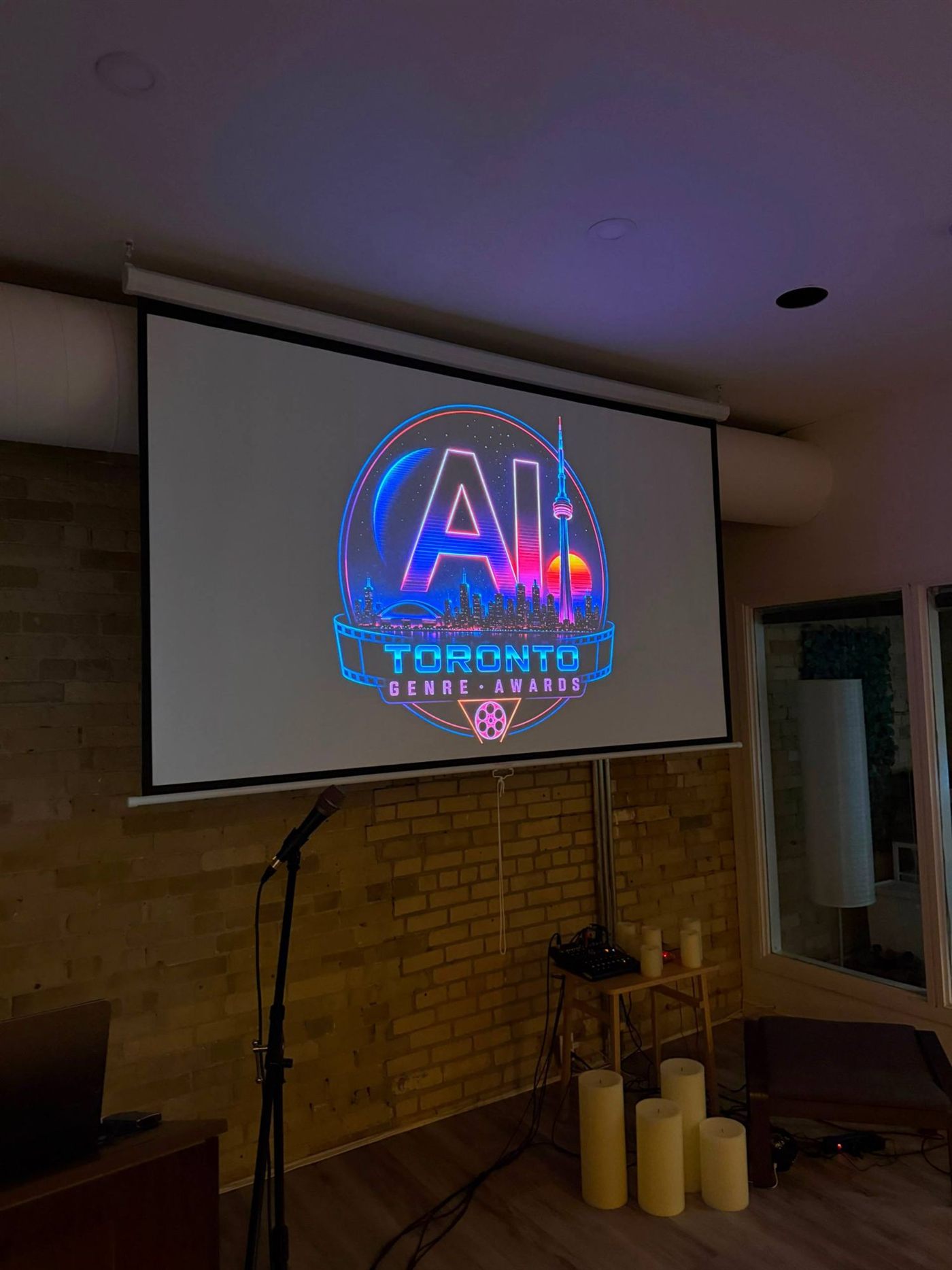 AI Toronto Genre Awards logo on the venue screen before the screening
