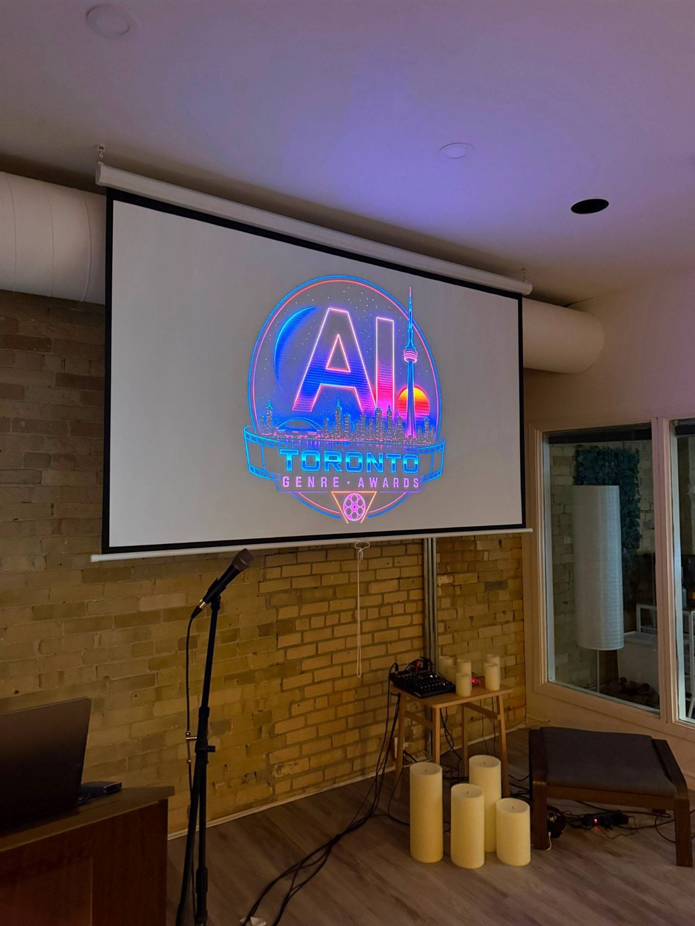 AI Toronto Genre Awards logo on the venue screen, wide shot